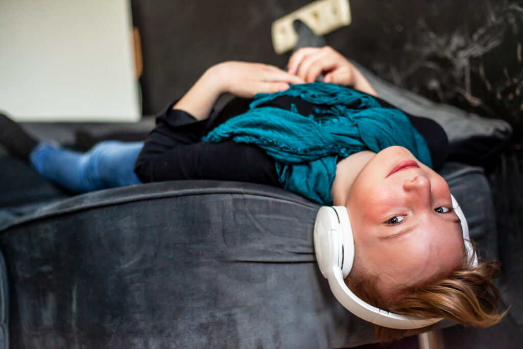 Young boy wearing headphones at home, showing how music helps children relax, focus, and connect with their emotions