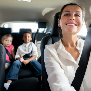 Mom drives while two children listen to music in the back seat, showing how music helps children connect through everyday experiences.