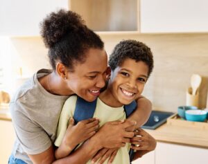 Mom helping her son follow a back-to-school routine for kids before the school day.