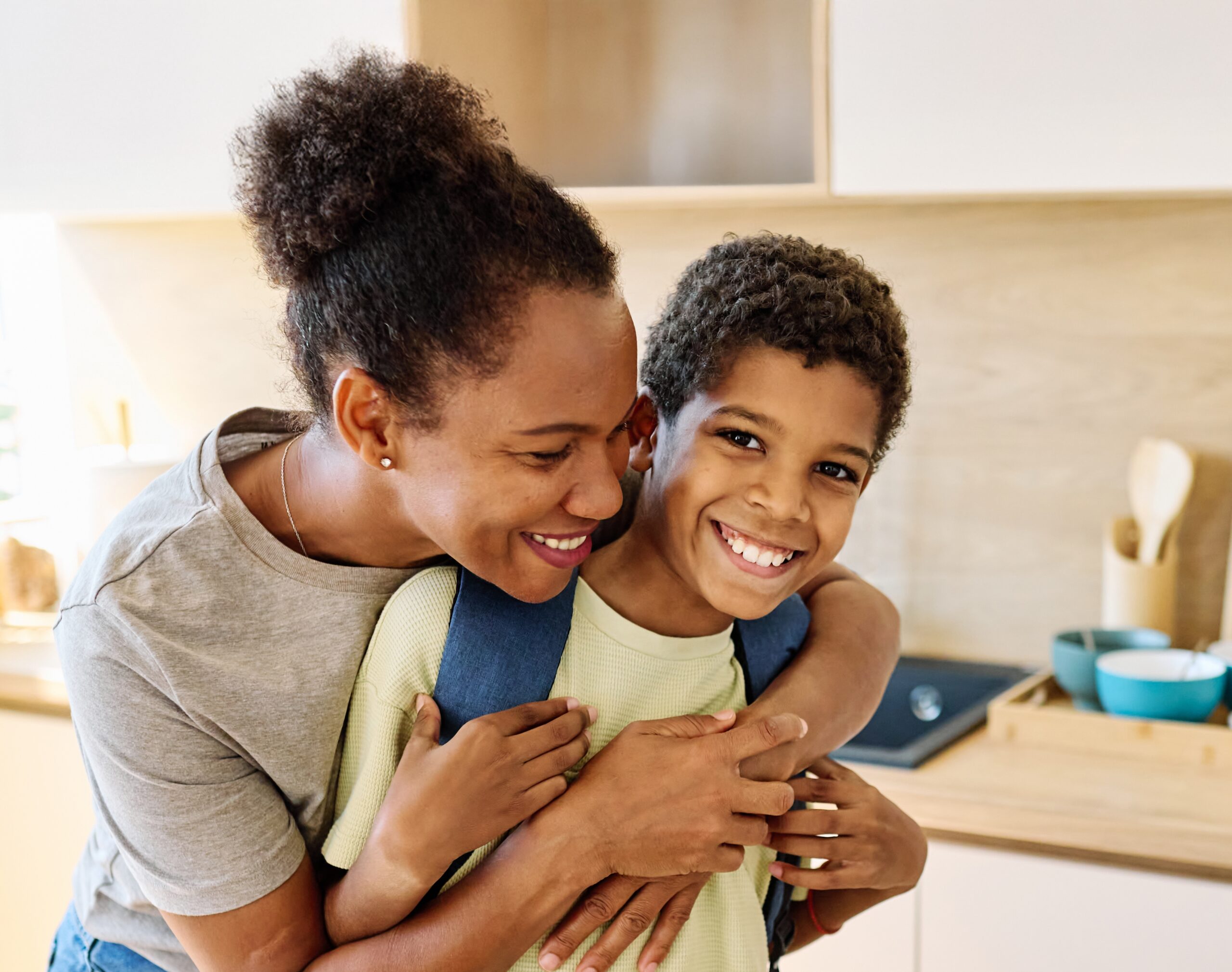 Mom helping her son follow a back-to-school routine for kids before the school day.